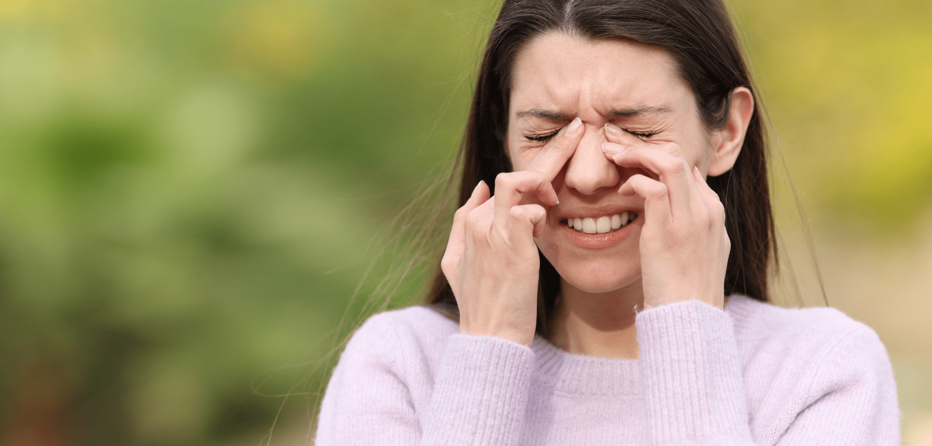 Photo of a woman sneezing.